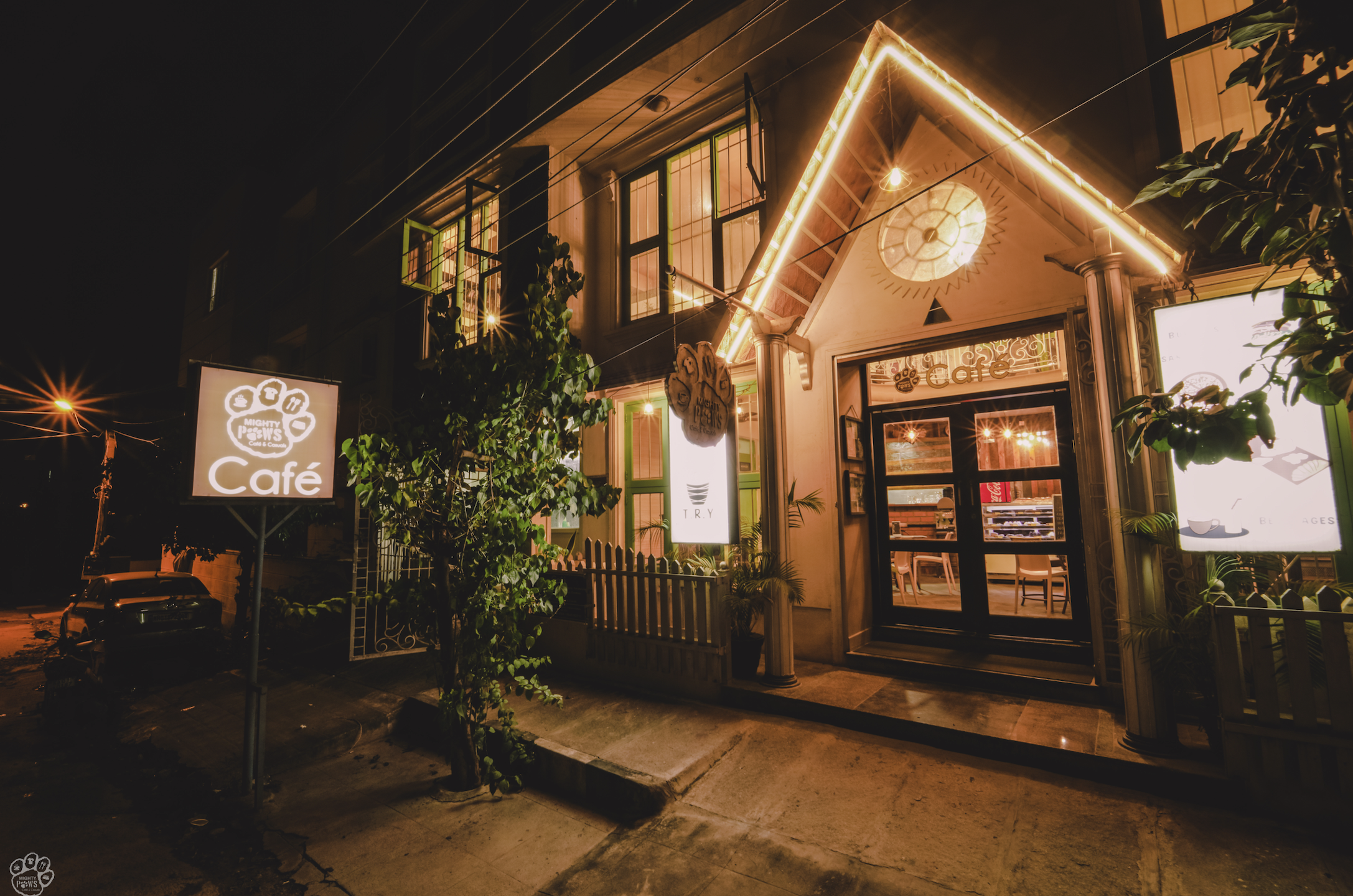 Entrance of Mighty Paws Cafe at night